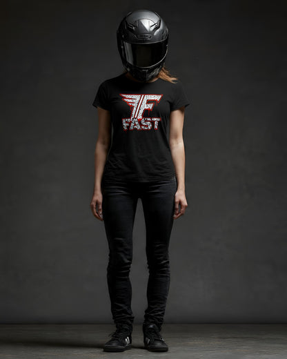 A full-body studio shot of a woman wearing a superbike t-shirt, motorcycle enthusiast apparel, and art shirt, black pants, and a black helmet.