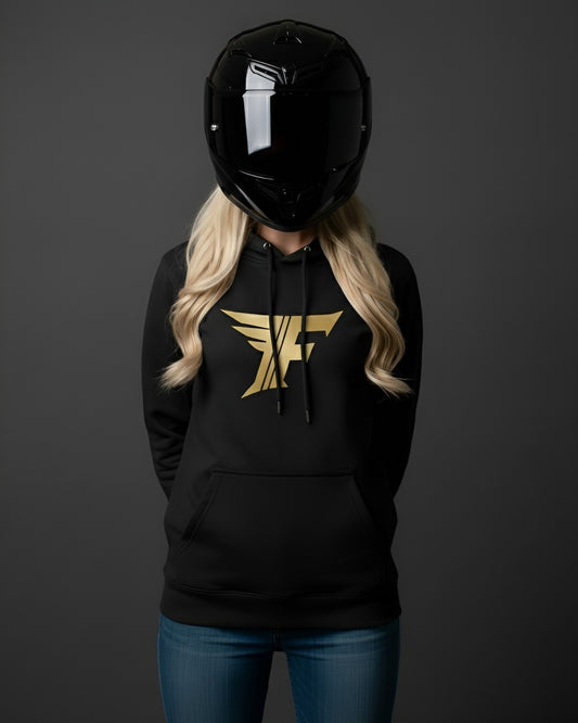 Black hoodie with gold winged "F" logo on the chest, modeled by a person wearing a shiny black motorcycle helmet and blonde hair over blue jeans.