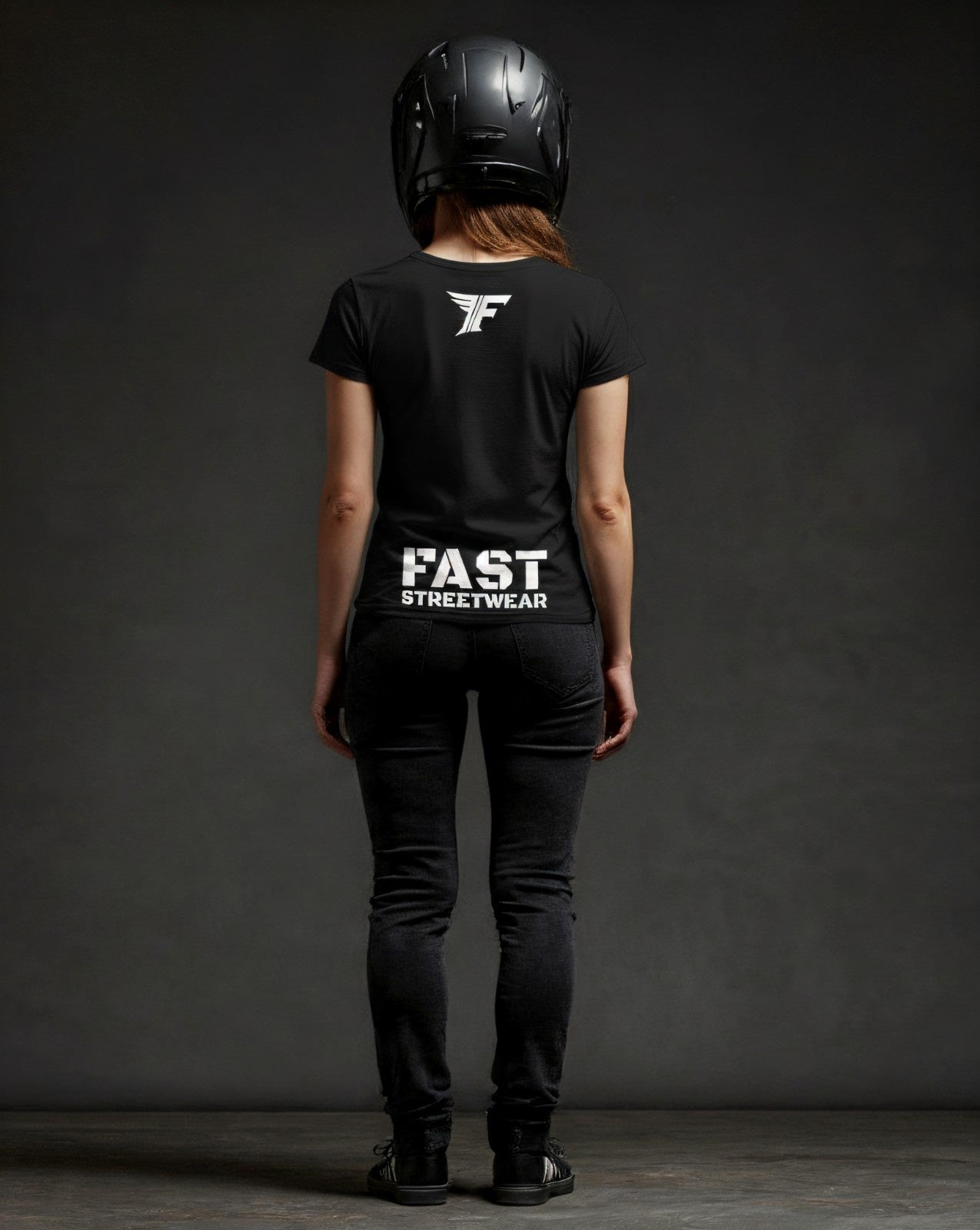 Person wearing a black t-shirt with 'FAST STREETWEAR' text and logo, black helmet, and black pants on a dark background.
