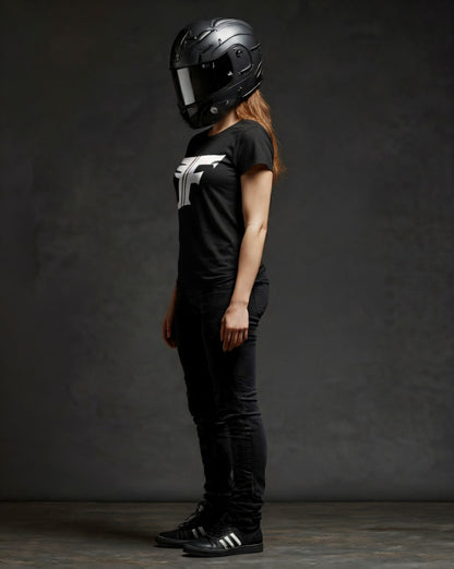 Person wearing a black helmet and black t-shirt with a logo on a dark background