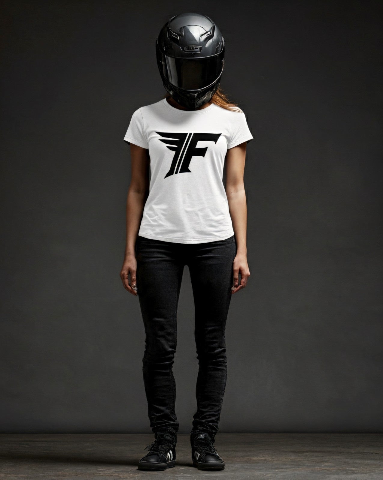 Person wearing a white t-shirt with a logo and a helmet on a dark background