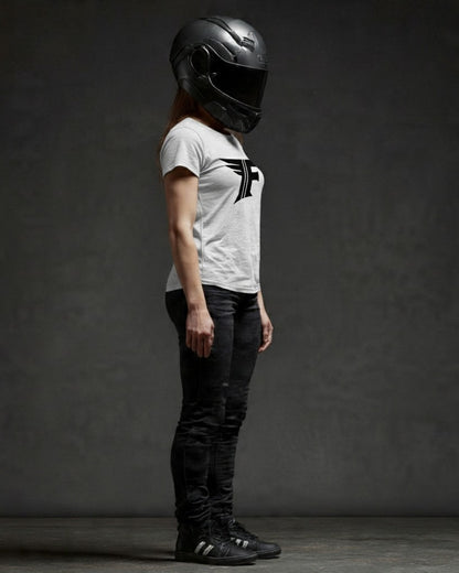 Person wearing a black helmet and white t-shirt with a logo against a dark background