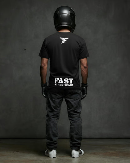 Person wearing a black t-shirt with 'FAST Streetwear' logo, black helmet, and dark pants against a gray background.