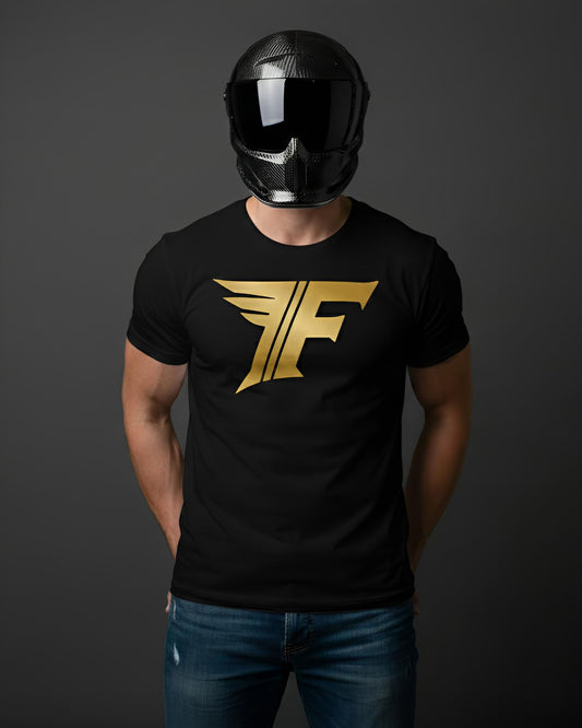 Black t-shirt featuring a large, stylized gold "F" logo with wing designs, worn by a man in a carbon fiber helmet and jeans.