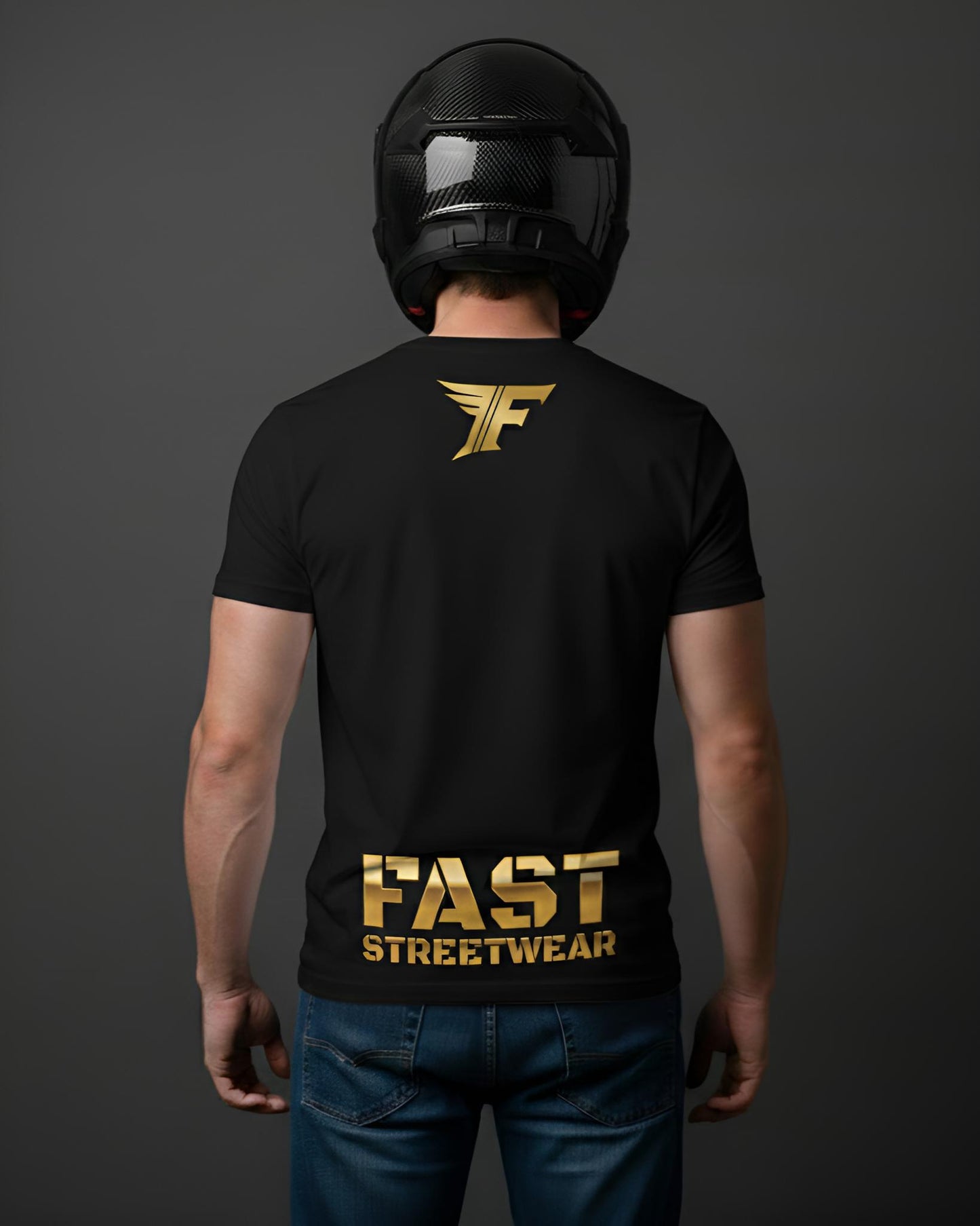 A black t-shirt, viewed from the back on a person wearing a motorcycle helmet, features a small gold 'F' logo on the upper back and large gold text saying 'FAST STREETWEAR' near the bottom.