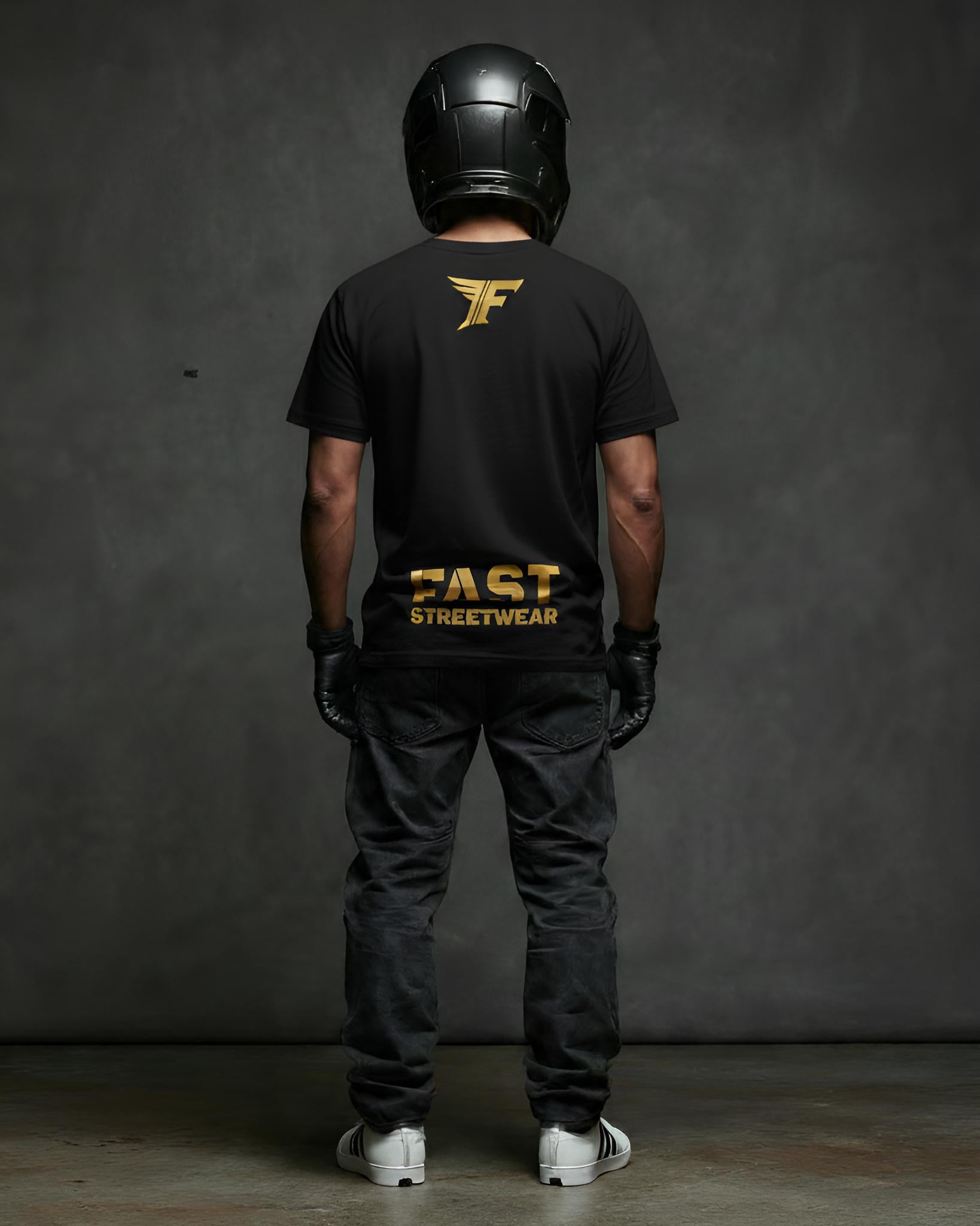 Black t-shirt featuring a gold wing logo and the bold gold text "FAST STREETWEAR" on the back, modeled by a person wearing a helmet and gloves.