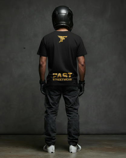 Black t-shirt featuring a gold wing logo and the bold gold text "FAST STREETWEAR" on the back, modeled by a person wearing a helmet and gloves.