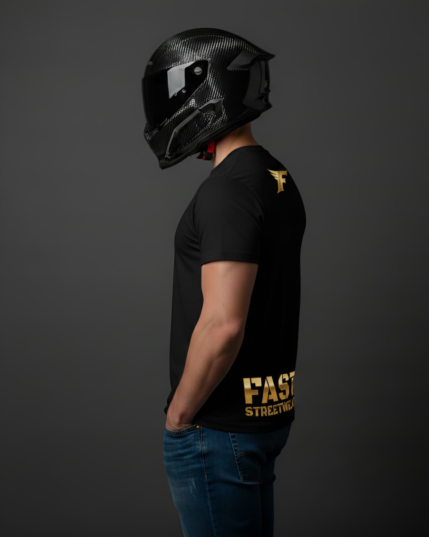 Black T-shirt with metallic gold "F" logo on the upper back and "FAST STREETWEAR" text on the lower back, worn by a man in a carbon fiber helmet.