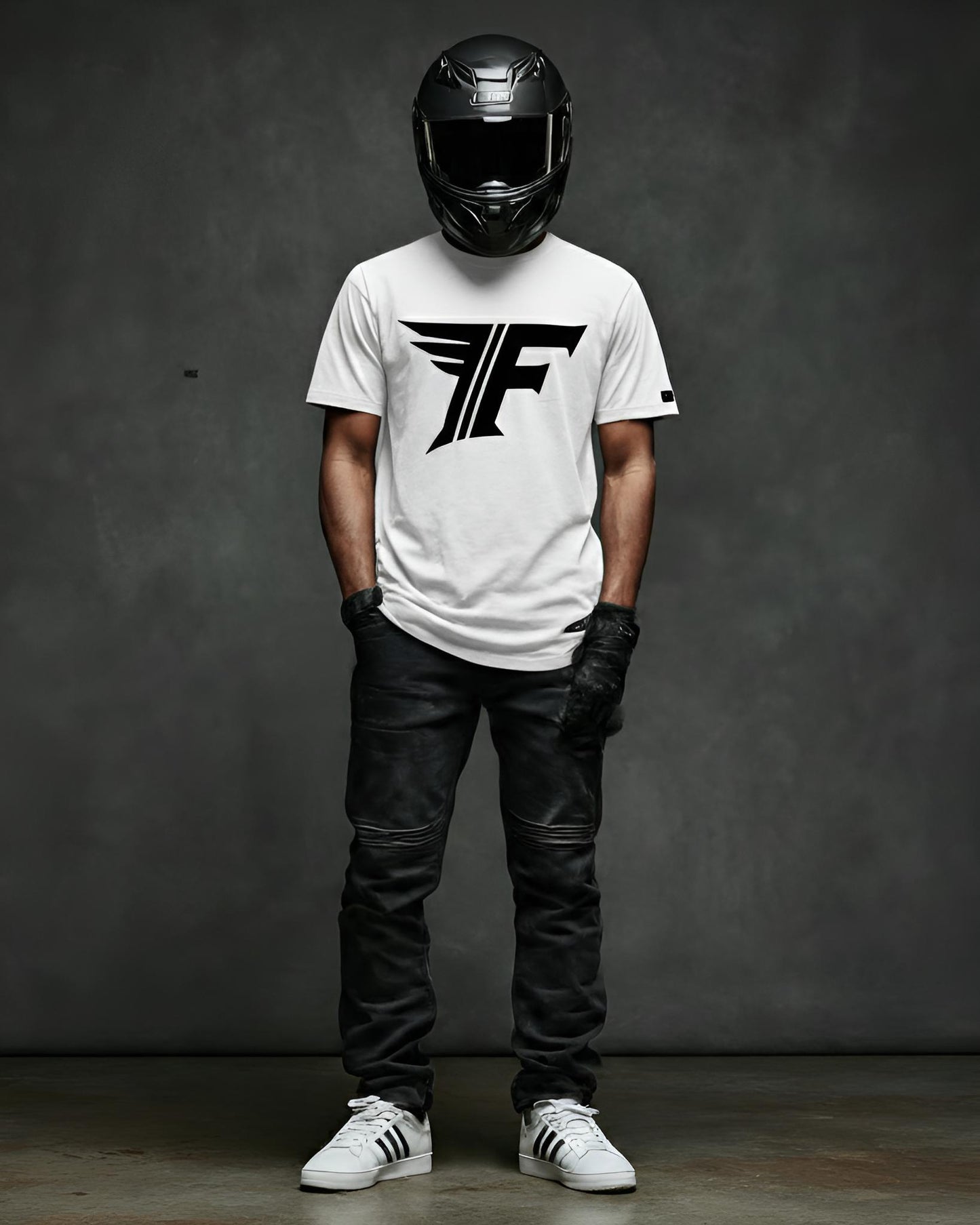 Person wearing a white t-shirt with a logo, black helmet, and leather pants against a dark background