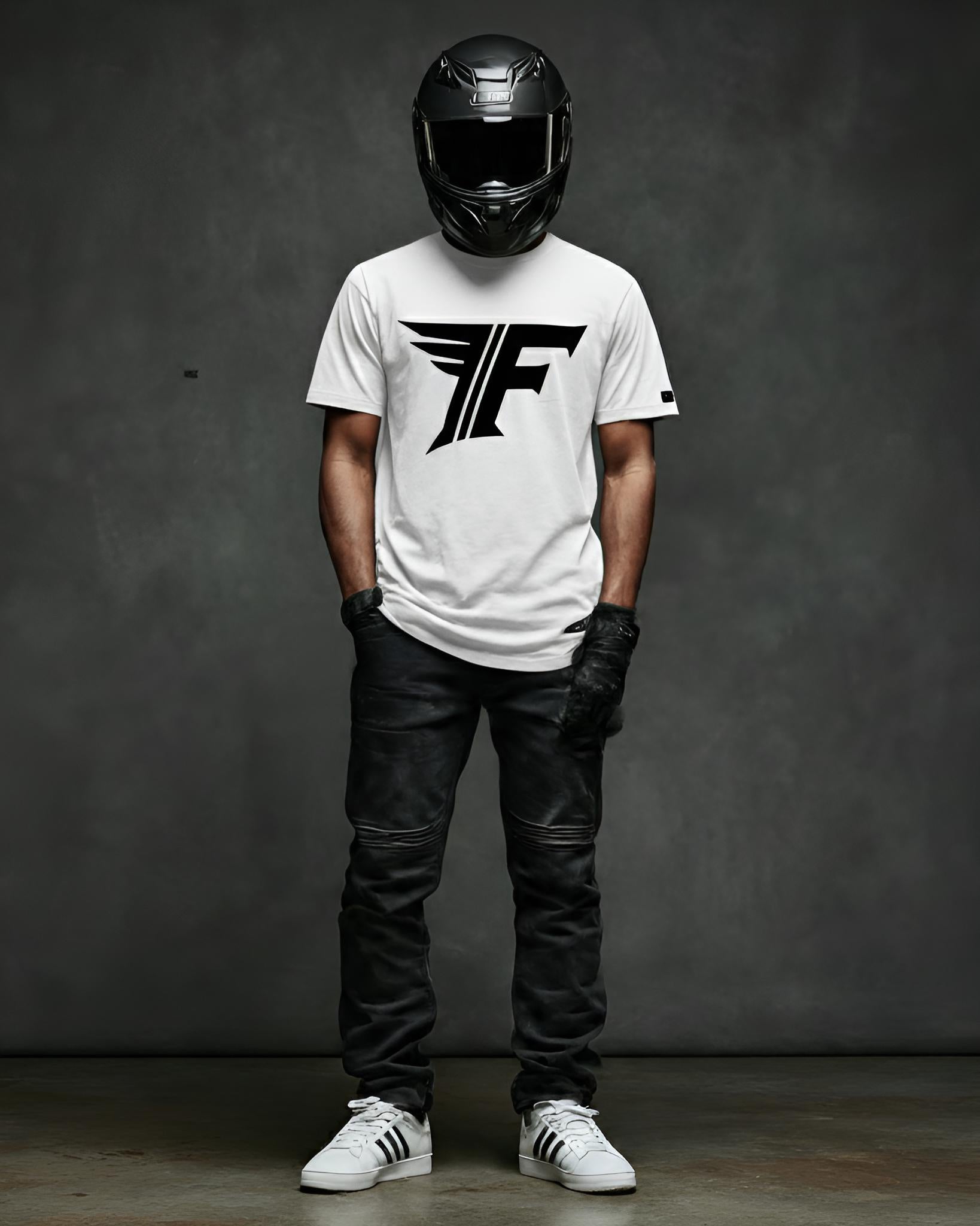 Person wearing a white t-shirt with a logo, black helmet, and leather pants against a dark background