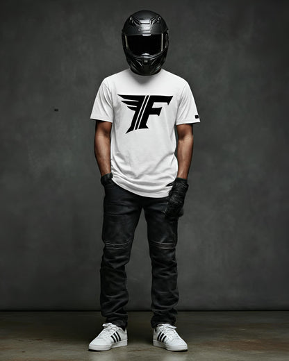 Person wearing a white t-shirt with a logo, black helmet, and leather pants against a dark background