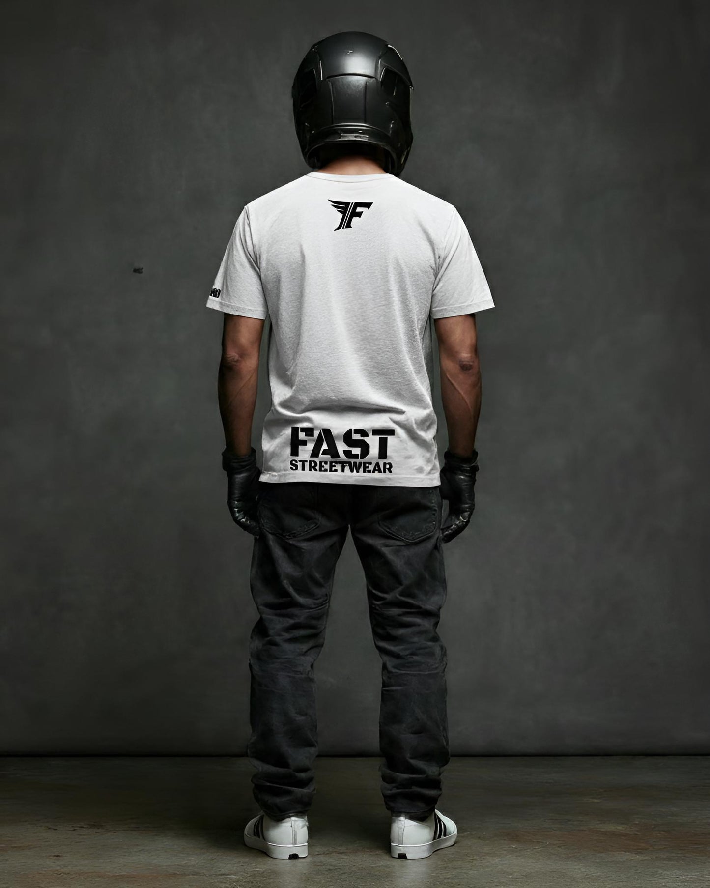 Person wearing a white t-shirt with 'FAST STREETWEAR' branding, black helmet, and dark pants against a gray background.