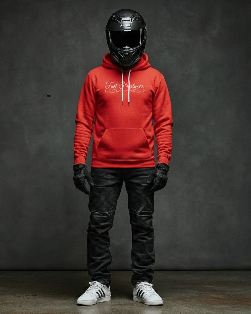 Person wearing a red hoodie, black helmet, leather pants, and white sneakers against a dark background