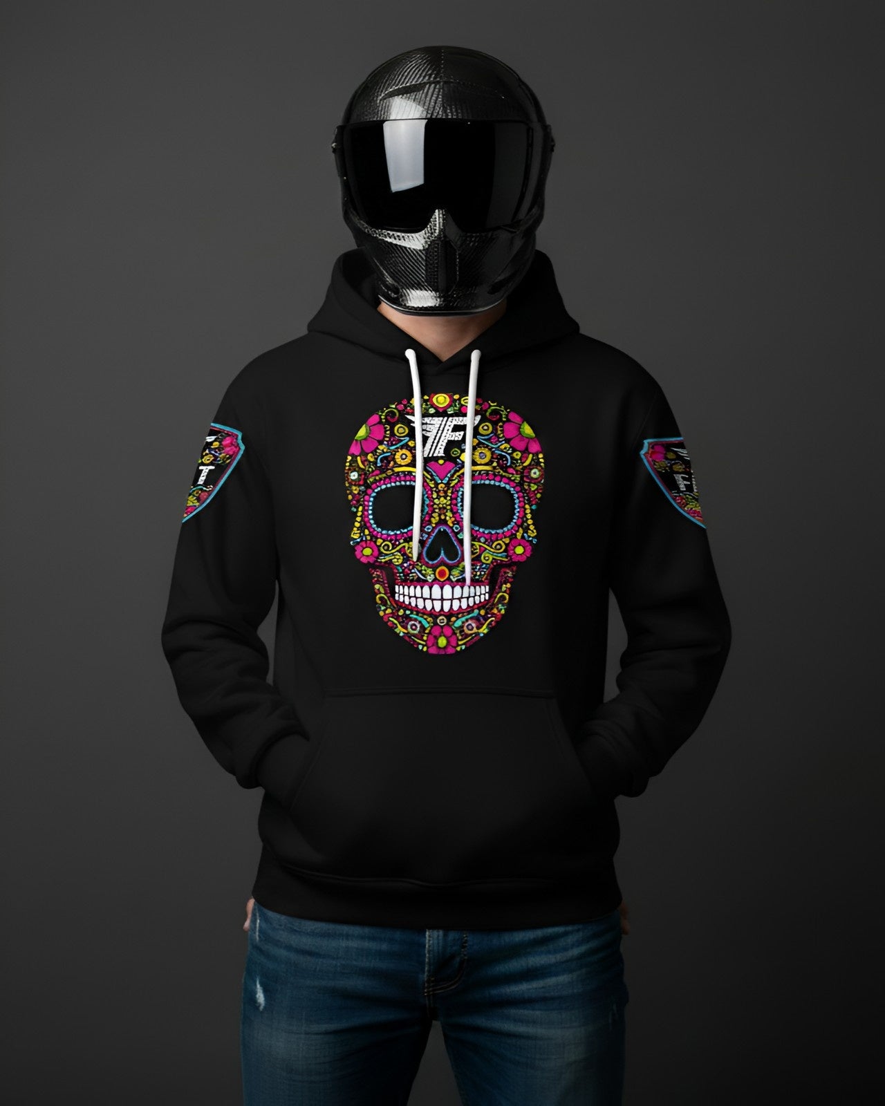 Black hoodie with a bright, intricate, multi-colored sugar skull graphic on the chest. Model wears a full-face carbon fiber motorcycle helmet.