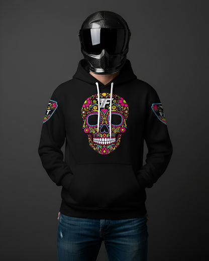 Black hoodie with a bright, intricate, multi-colored sugar skull graphic on the chest. Model wears a full-face carbon fiber motorcycle helmet.