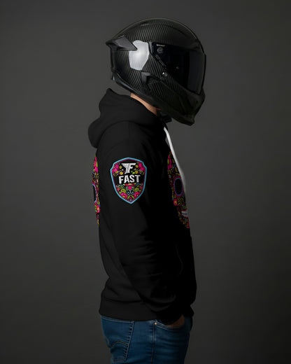 Right side view of black hoodie showing the colorful shield "FAST" logo patch on the right shoulder. Model wears a black motorcycle helmet.