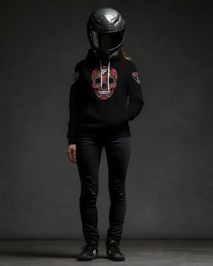 Black hoodie with colorful, detailed sugar skull design on the chest, worn by a figure in a motorcycle helmet and dark jeans. Patches on sleeves.