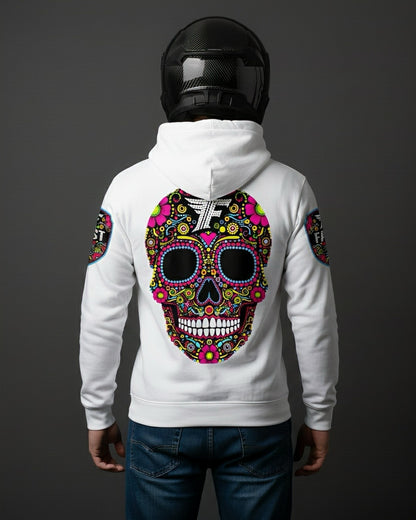 Back view of the white hoodie featuring a large, brightly colored Day of the Dead sugar skull design. Worn by a person in a carbon fiber motorcycle helmet.
