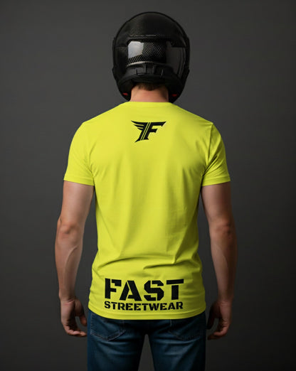 A man in a black helmet wears a fluorescent yellow T-shirt with a black "F" logo on the upper back and the text "FAST STREETWEAR" near the bottom.
