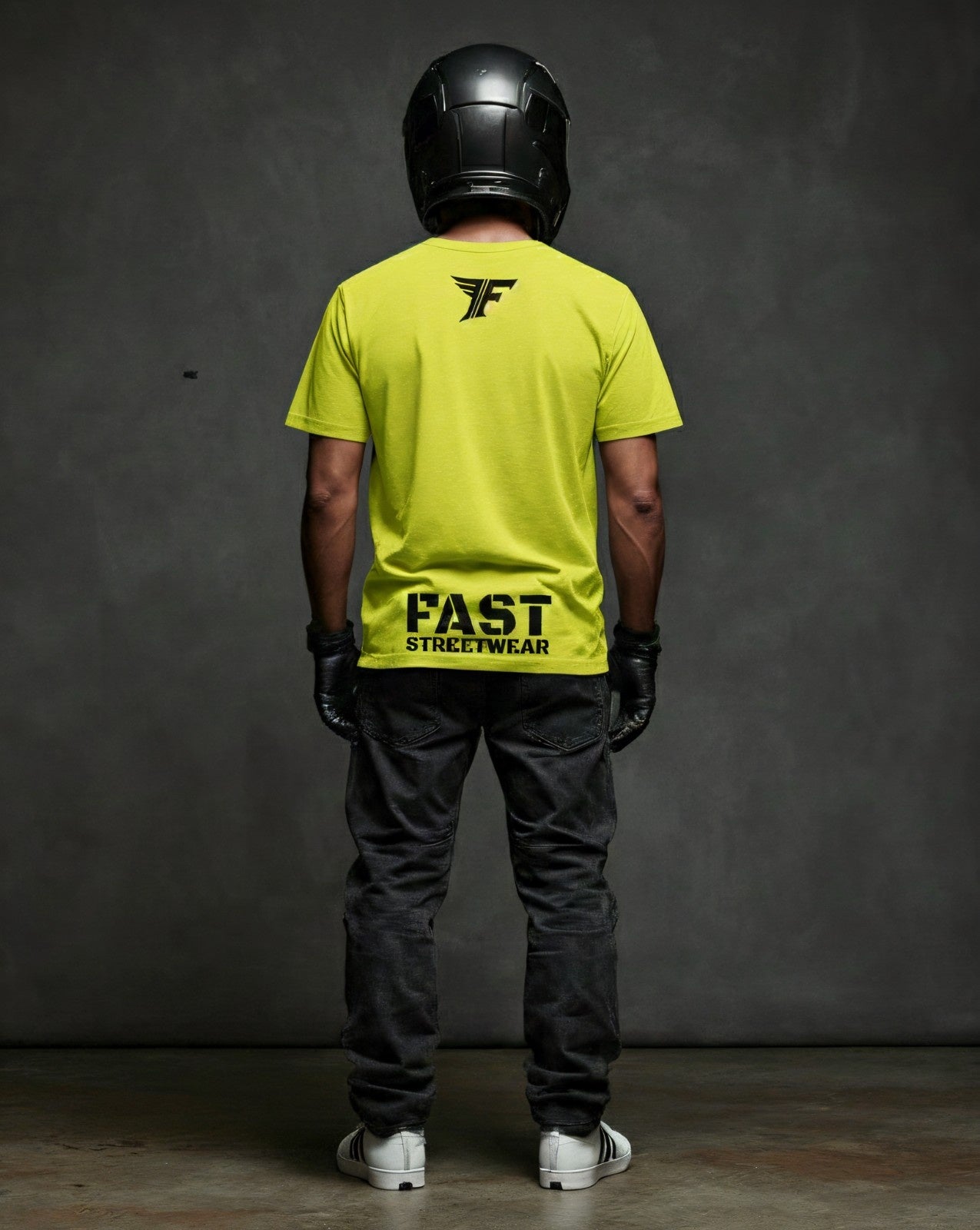 Neon Yellow FAST STREETWEAR T-shirt for men or women. Black logo and winged F graphic on the back. Shown on a model wearing a helmet & gloves.