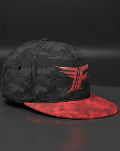 Black and red camouflage cap with a logo on a dark background